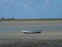 A boat is stranded on the mud flats